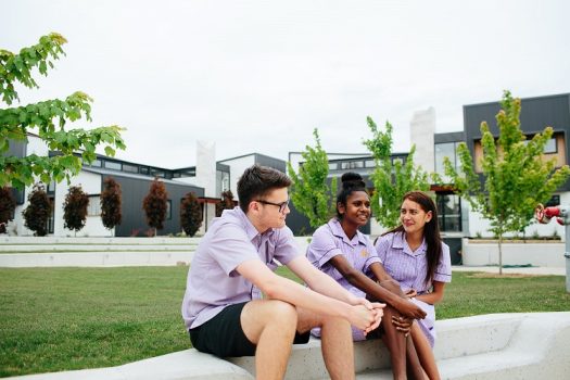 Students sitting outside their boarding houses